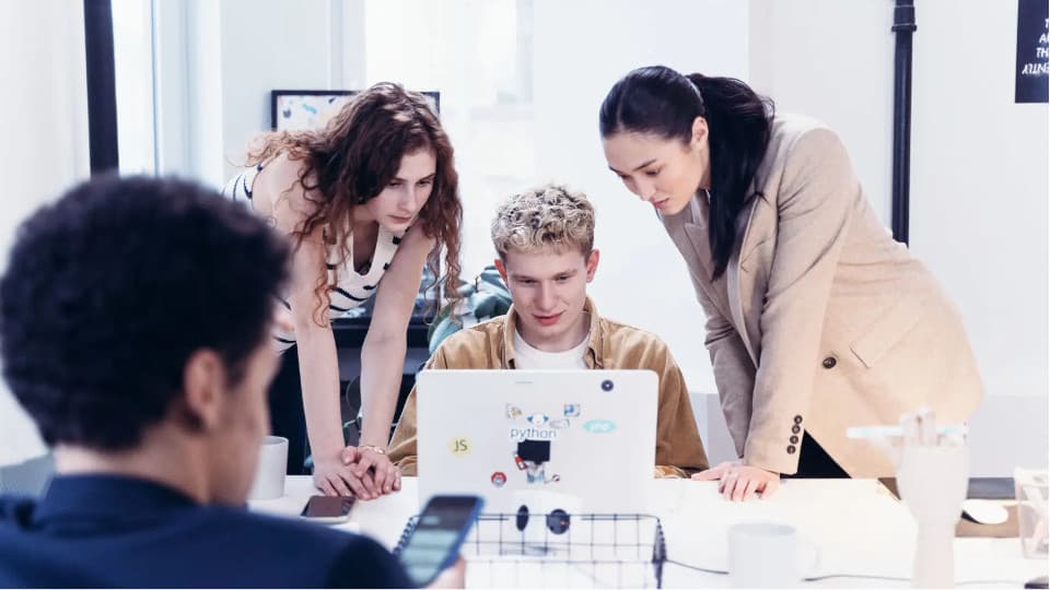 3 person looking at laptop screen