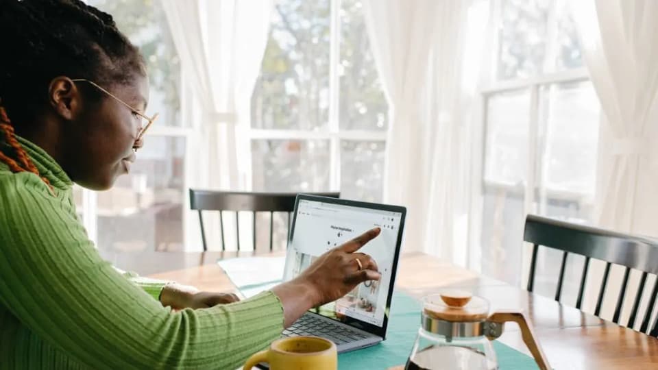 woman touching her laptop screen