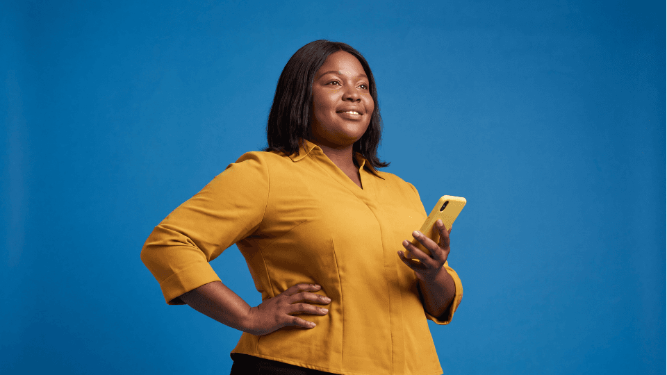 woman yellow shirt phone confident